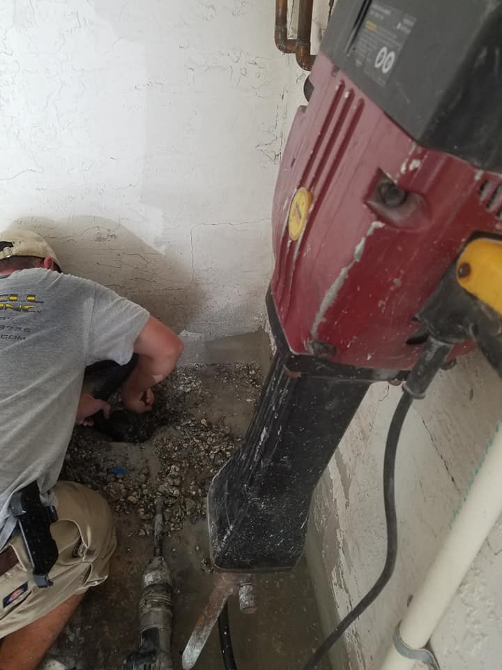 Plumber excavating for sewer repair